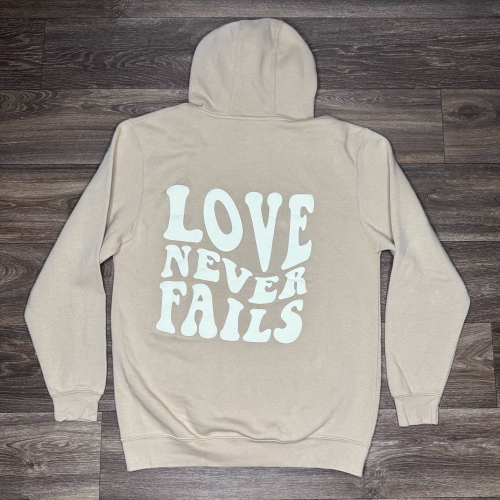 Tan Sweatshirt with 'Love Never Fails' Design Size Medium